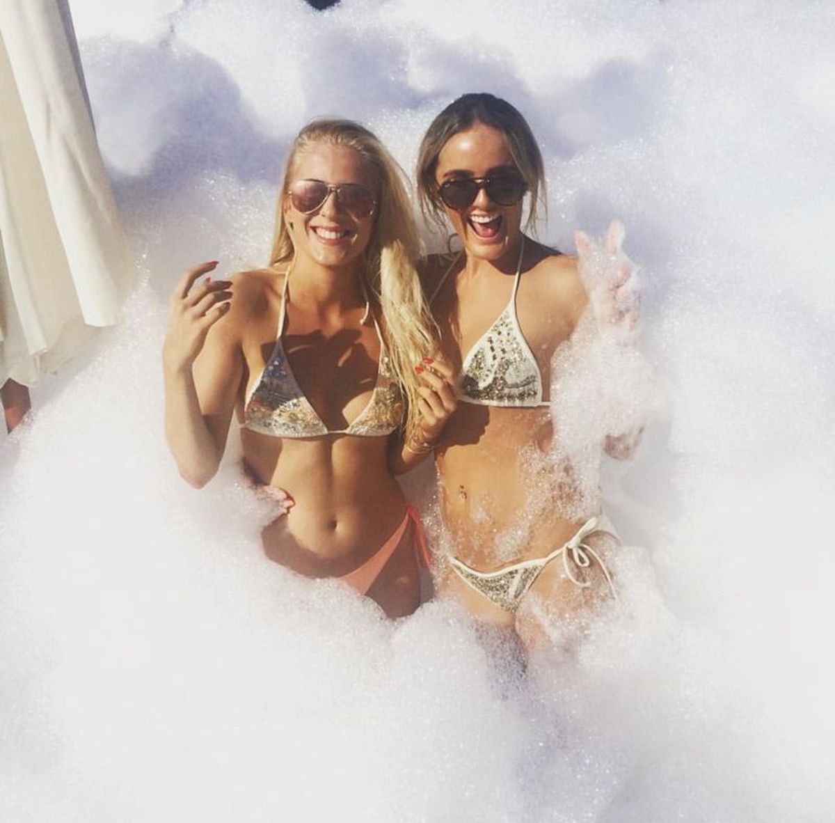 Foam Party with guests playing in thick bubbles outdoors