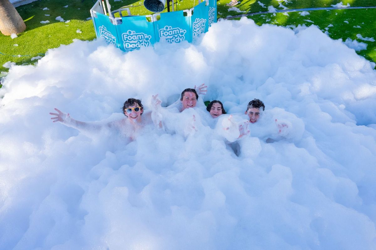 Group having fun at a foam party add‑on available with the VR trailer